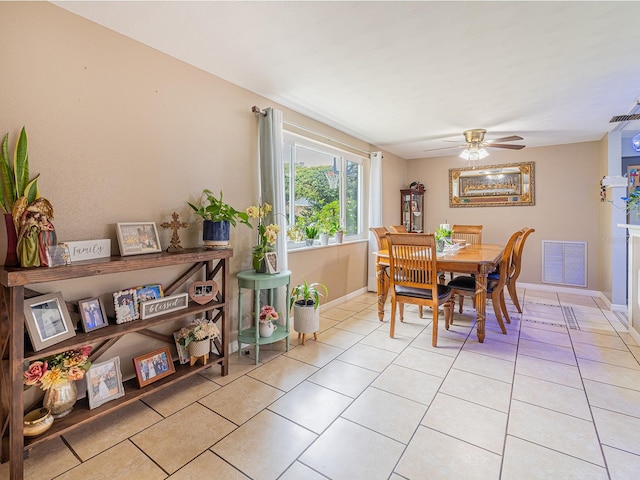 dining space featuring light tile patterned floors, visible vents, and baseboards