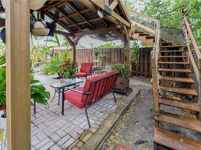 view of patio featuring a gazebo, stairway, and fence