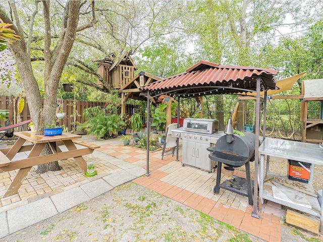 view of patio / terrace featuring a gazebo and fence