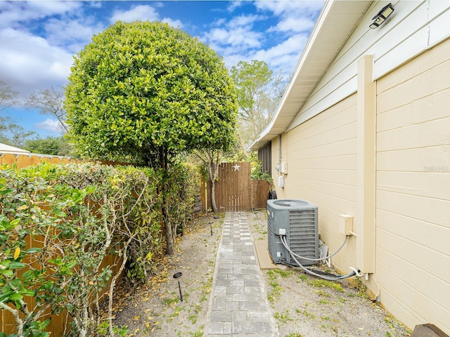 view of yard featuring central air condition unit and fence