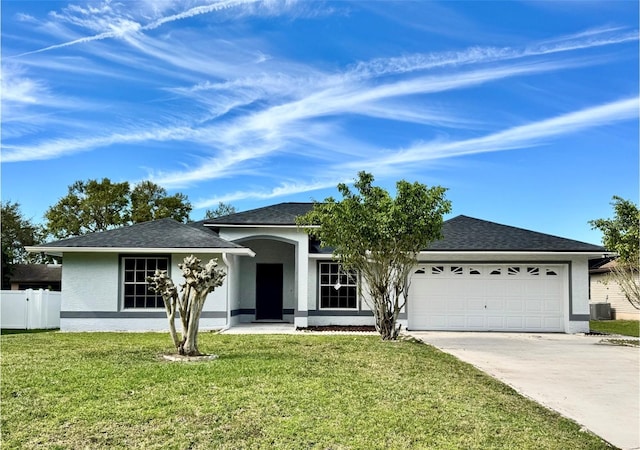 ranch-style home with a garage, central AC unit, concrete driveway, stucco siding, and a front yard