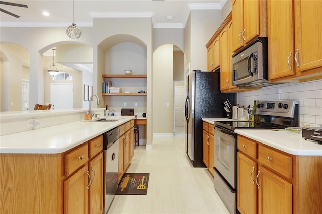 kitchen with appliances with stainless steel finishes, ornamental molding, light countertops, open shelves, and a sink