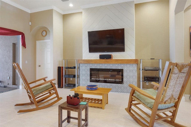 living area with ornamental molding and a fireplace