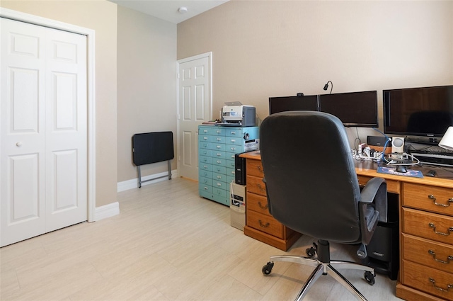 office area with light wood finished floors and baseboards