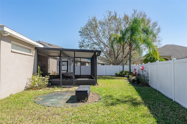 view of yard featuring a sunroom and a fenced backyard