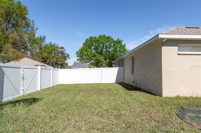 view of yard featuring a gate and a fenced backyard