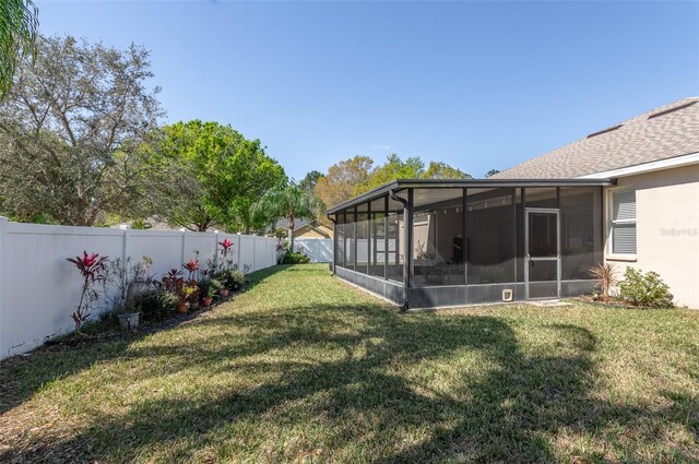 view of yard with a sunroom and a fenced backyard