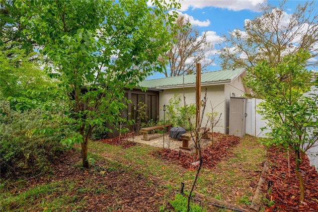 view of yard with a sunroom, a gate, and fence