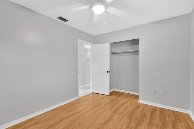 unfurnished bedroom with a closet, visible vents, light wood-style flooring, ceiling fan, and baseboards