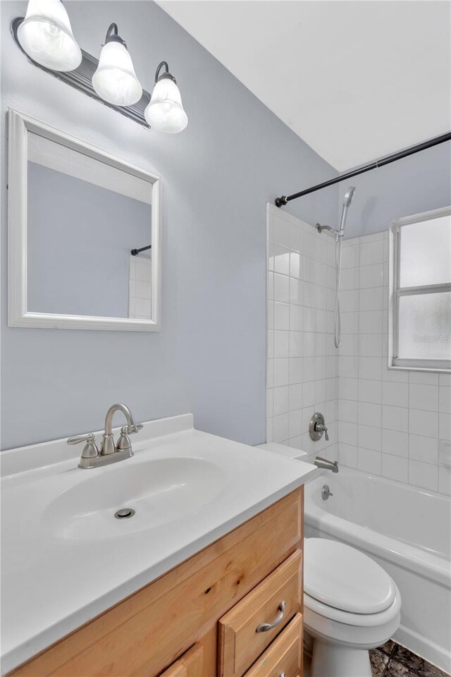 bathroom featuring toilet, bathing tub / shower combination, and vanity