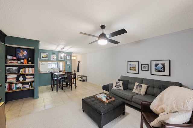 tiled living room featuring ceiling fan and a textured ceiling