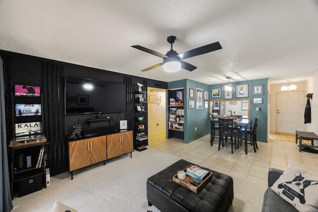 living area with a textured ceiling and ceiling fan with notable chandelier