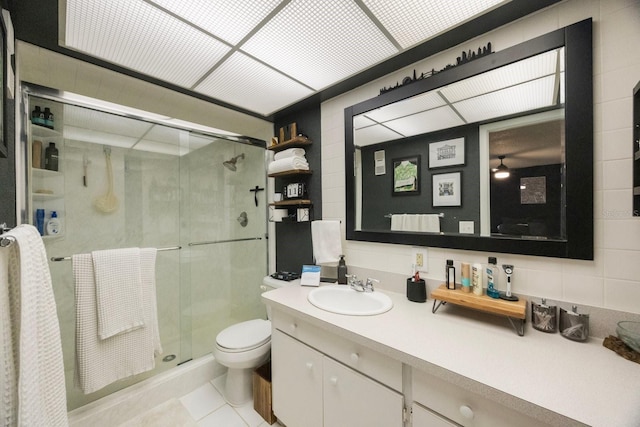 full bath with vanity, tile patterned flooring, a shower stall, and toilet