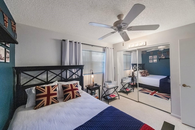 bedroom featuring carpet, a closet, ceiling fan, and a textured ceiling