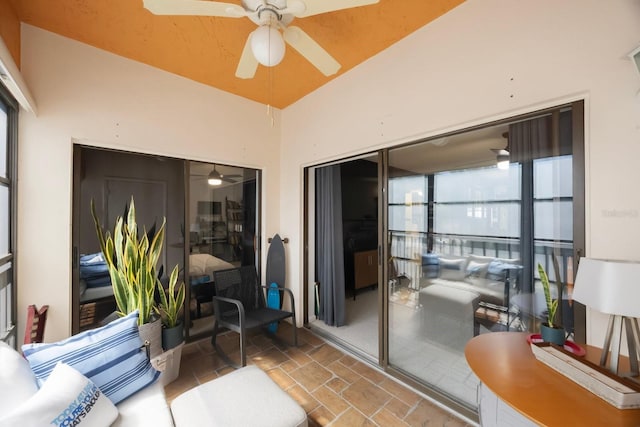 sunroom featuring a ceiling fan