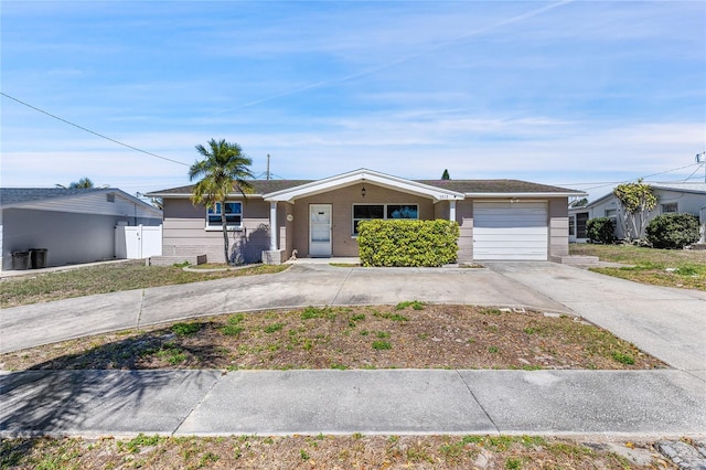 ranch-style house with a garage and concrete driveway