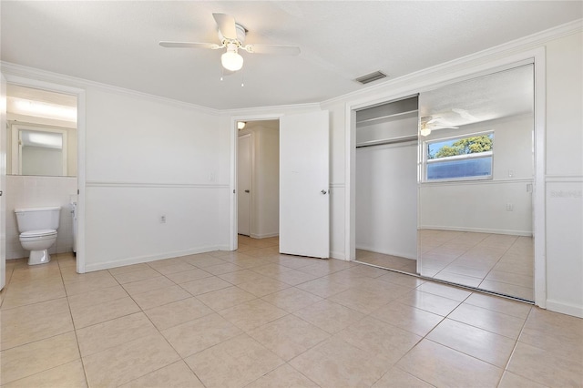 unfurnished bedroom featuring visible vents, ornamental molding, a closet, and light tile patterned flooring