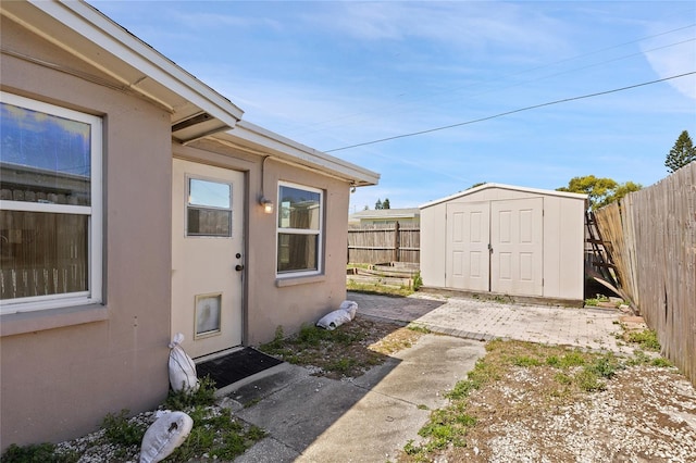 doorway to property with fence and stucco siding