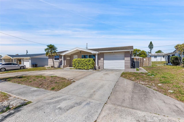 single story home featuring driveway, an attached garage, and fence