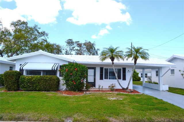 single story home featuring an attached carport, stucco siding, driveway, and a front yard