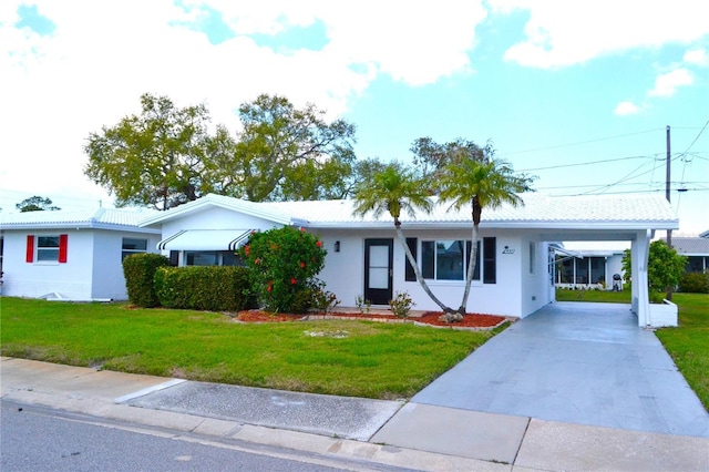 single story home featuring a carport, a front lawn, concrete driveway, and stucco siding