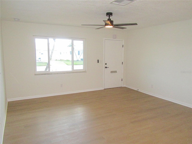 unfurnished room featuring wood finished floors and baseboards