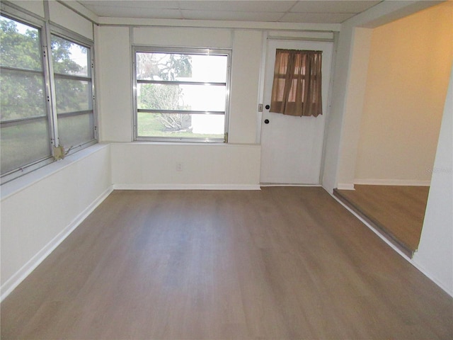 unfurnished sunroom with a paneled ceiling