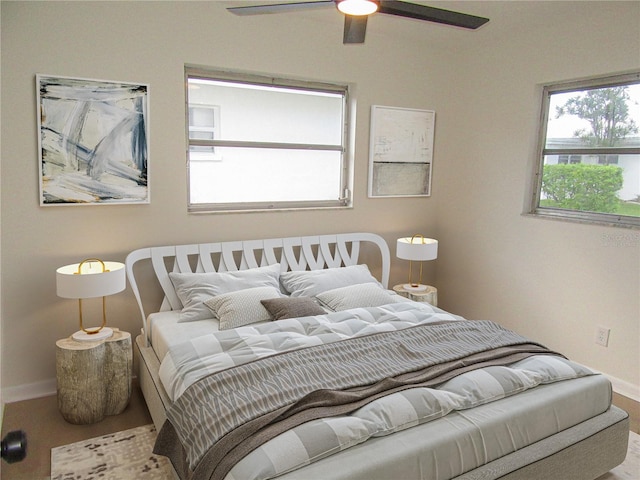 bedroom with a ceiling fan, baseboards, and wood finished floors