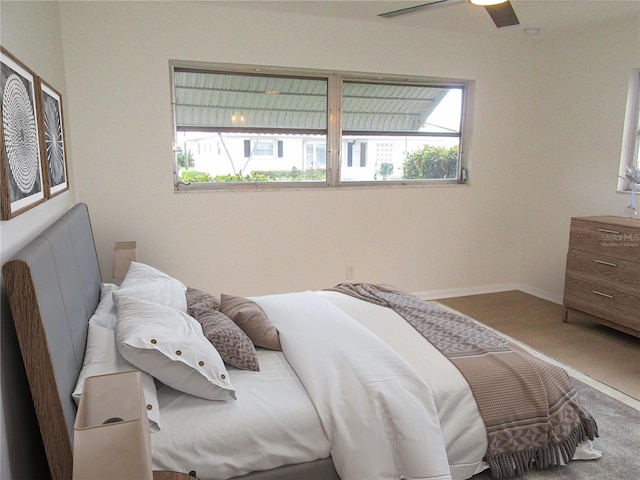 bedroom with ceiling fan and baseboards