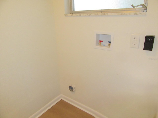 laundry area featuring laundry area, baseboards, and washer hookup