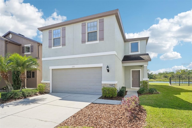 view of front of home with a front lawn, stucco siding, a garage, stone siding, and driveway