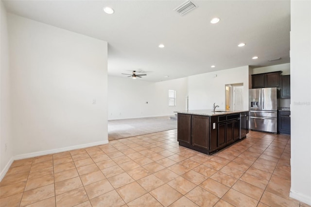 kitchen with a sink, visible vents, dark brown cabinetry, and appliances with stainless steel finishes