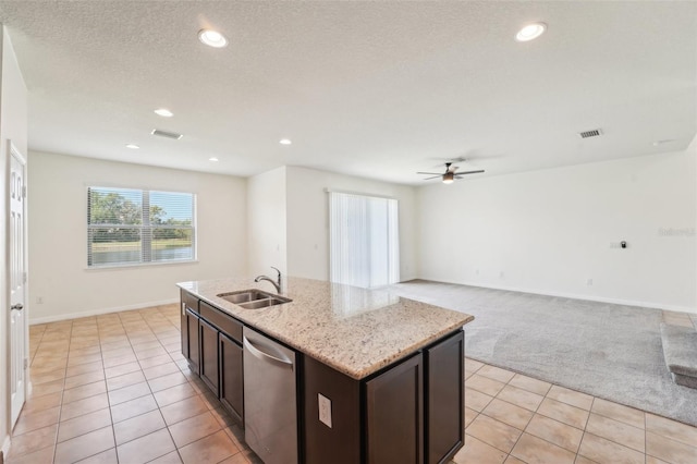 kitchen featuring stainless steel dishwasher, light tile patterned flooring, a ceiling fan, and a sink