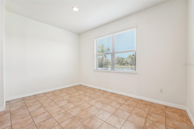 unfurnished room with recessed lighting and baseboards