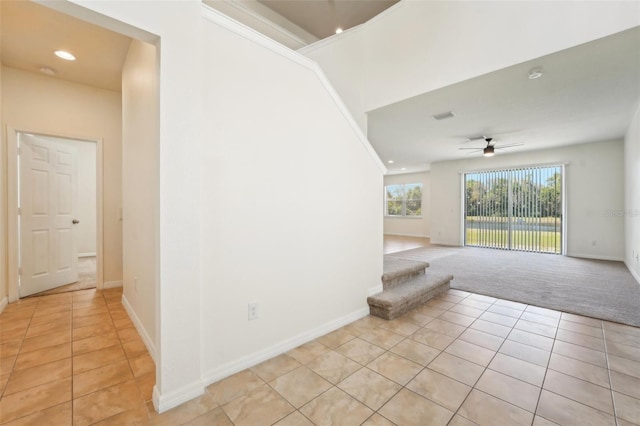 interior space featuring light tile patterned floors, visible vents, light carpet, and baseboards