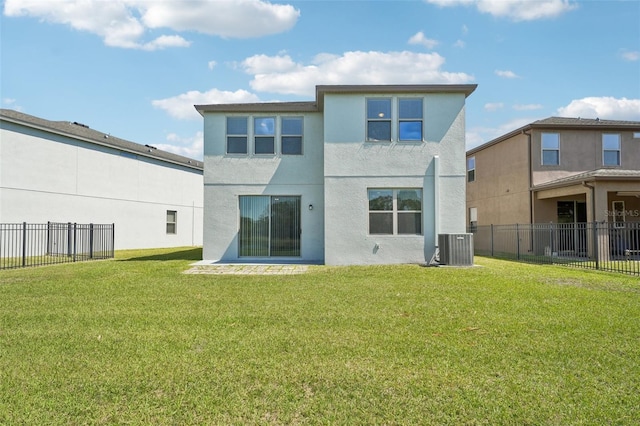 back of property with central AC unit, a yard, fence, and stucco siding