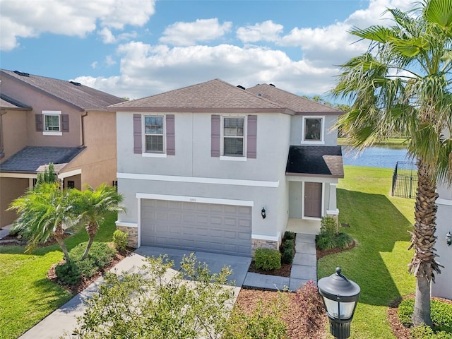 traditional home with concrete driveway, a front yard, stucco siding, stone siding, and an attached garage