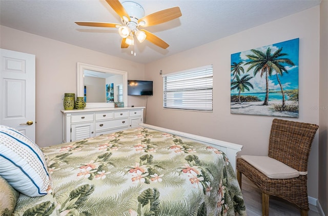 bedroom with ceiling fan and wood finished floors