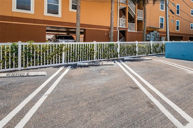 uncovered parking lot featuring fence