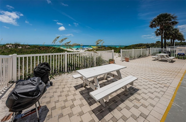 view of patio / terrace featuring outdoor dining area, a grill, and fence