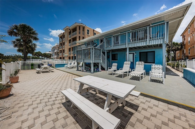 surrounding community with outdoor dining area, a patio area, and fence