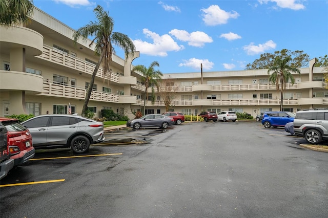 view of building exterior with uncovered parking