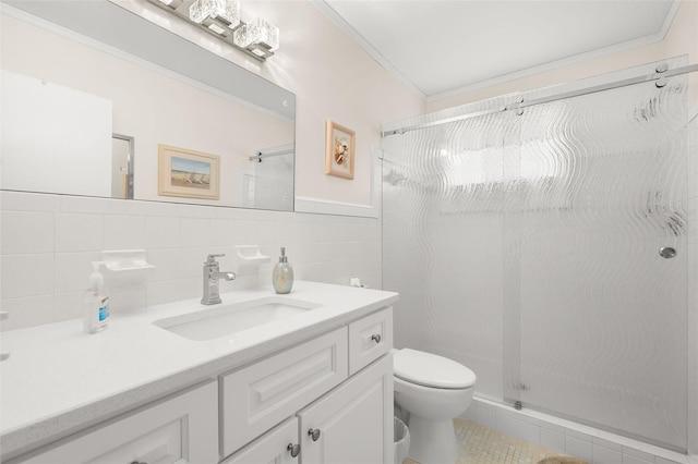 bathroom with toilet, a shower stall, and ornamental molding