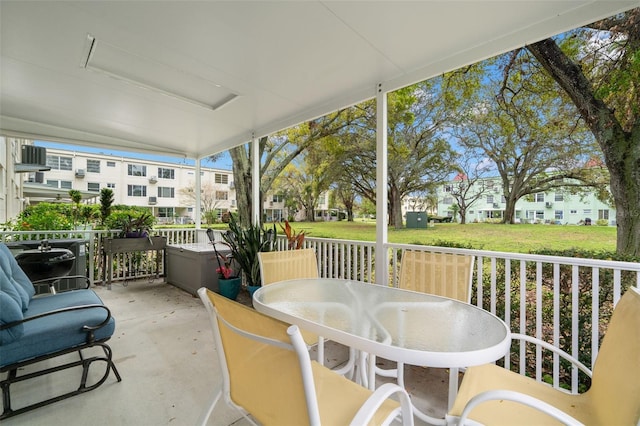 sunroom / solarium featuring a residential view