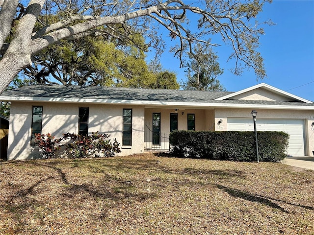 view of front facade featuring a garage and stucco siding