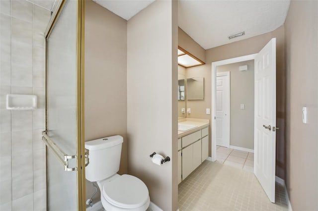 bathroom with vanity, toilet, visible vents, and a stall shower