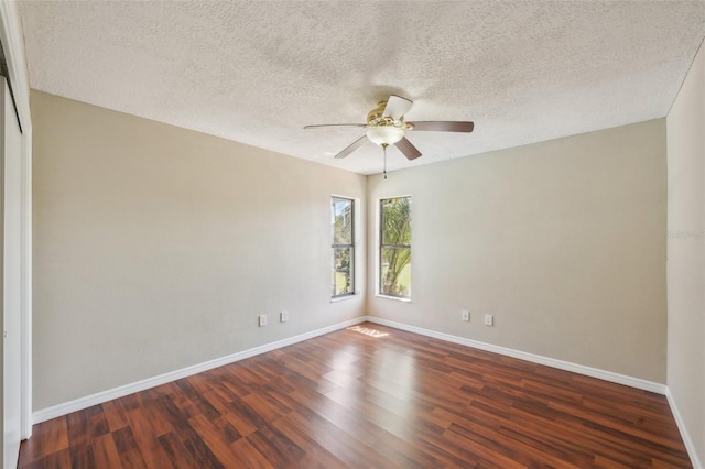 spare room featuring a ceiling fan, wood finished floors, baseboards, and a textured ceiling