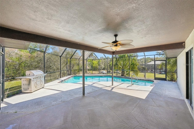 pool featuring glass enclosure, grilling area, ceiling fan, and a patio area