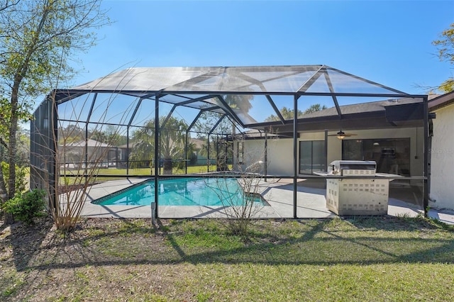 outdoor pool featuring glass enclosure, a lawn, and a patio area