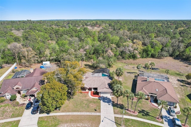 birds eye view of property with a forest view